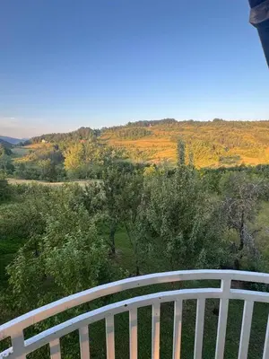 a white fence with a view of a field at Vikendica Savić in Šipovo