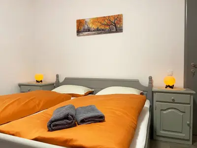 a bedroom with two beds with towels on the bed at Soba za goste Kraljica 4 in Kupres