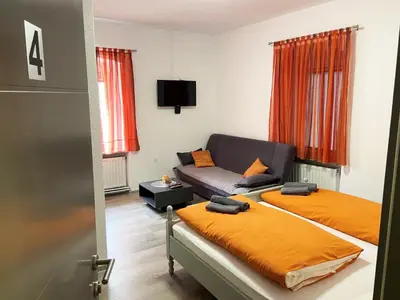a living room with two beds and a couch at Soba za goste Kraljica 4 in Kupres