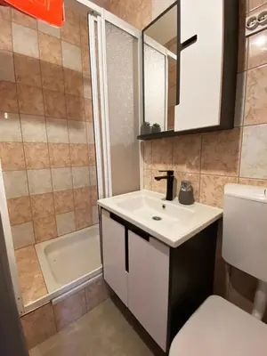 a bathroom with a sink and a toilet and a tub at Soba za goste Kraljica 4 in Kupres