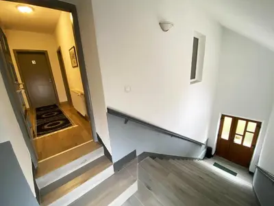 an empty hallway with a stairway leading to a room at Soba za goste Kraljica 4 in Kupres