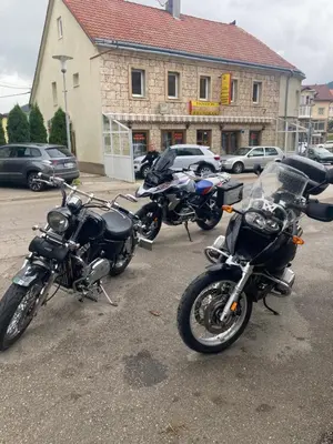 a row of motorcycles parked in a parking lot at Soba za goste Kraljica 3 in Kupres