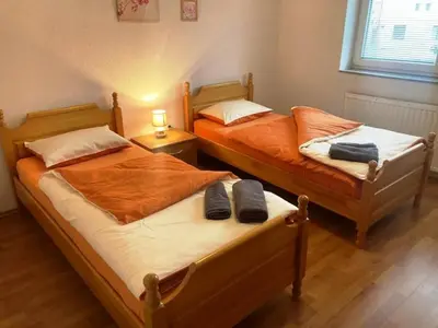two beds sitting next to each other in a bedroom at Apartman Kraljica 1 in Kupres