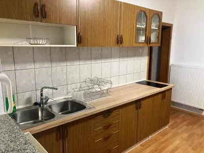a kitchen with a sink and wooden cabinets at Apartman Kraljica 1 in Kupres