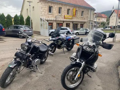 a group of motorcycles parked in a parking lot at Apartman Kraljica 1 in Kupres