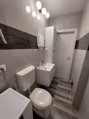 a bathroom with a white toilet and a sink at Apartman Cincar in Livno