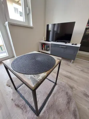 a coffee table in a living room with a tv at Apartman Cincar in Livno