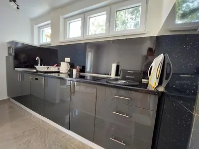 a kitchen with stainless steel cabinets and a counter top at Apartman Cincar in Livno