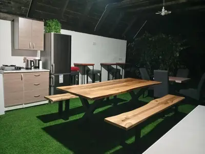 a wooden table and benches in a kitchen at Resort La Familia in Bihać