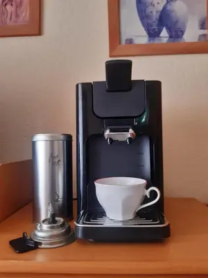 a coffee maker with a cup on a table at Apartman LEON in Livno