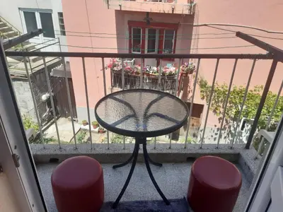 a balcony with a table and two stools at Apartman LEON in Livno