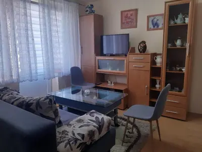 a living room with a couch and a table and a tv at Apartman LEON in Livno