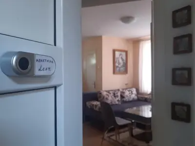 a living room with a blue couch and a table at Apartman LEON in Livno