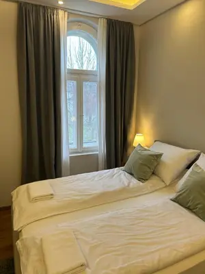 a bedroom with two beds and a window at Hotel Nacional in Bosanska Gradiška