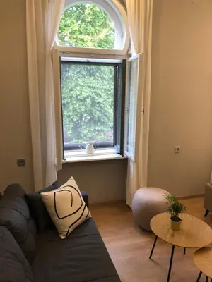 a living room with a couch and a window at Hotel Nacional in Bosanska Gradiška