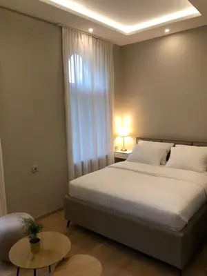 a bedroom with a large bed and a window at Hotel Nacional in Bosanska Gradiška