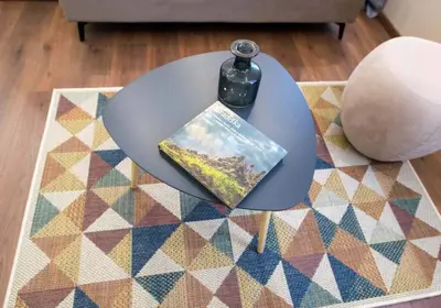 a book sitting on top of a table on a rug at Hotel Nacional in Bosanska Gradiška