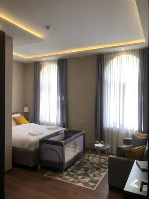 a hotel room with a bed and a couch at Hotel Nacional in Bosanska Gradiška