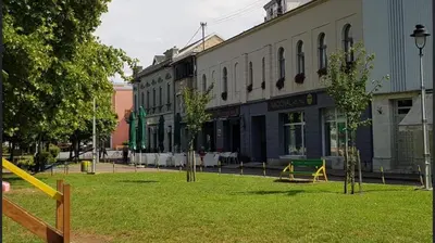 a park with trees in the middle of a street at Hotel Nacional in Bosanska Gradiška