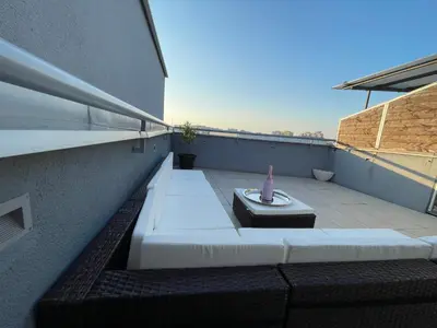 a balcony with a vase on top of a building at Amsterdam in Banja Luka
