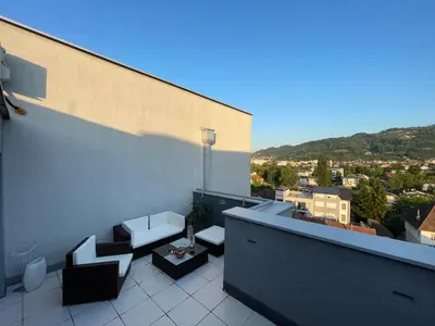 a balcony with couches and tables on a building at Amsterdam in Banja Luka