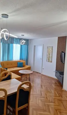 a living room with a couch and a table at centar apartment in Banja Luka