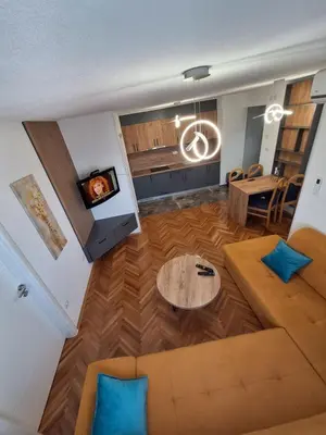 a living room with a couch and a table at centar apartment in Banja Luka