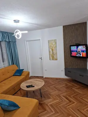 a living room with a couch and a tv at centar apartment in Banja Luka