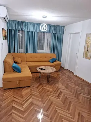 a living room with a couch and a table at centar apartment in Banja Luka