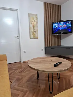 a living room with a coffee table and a tv at centar apartment in Banja Luka