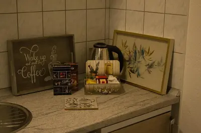 a counter with a coffee pot and a picture on it at VillaH Weekend House in Visoko