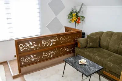 a living room with a couch and a table at VillaH Weekend House in Visoko