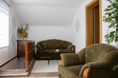 a living room with a couch and a chair at VillaH Weekend House in Visoko