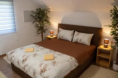 a bedroom with a bed with two yellow folders on it at VillaH Weekend House in Visoko