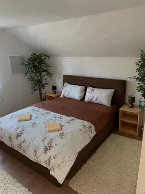 a bedroom with a bed with two pillows on it at VillaH Weekend House in Visoko