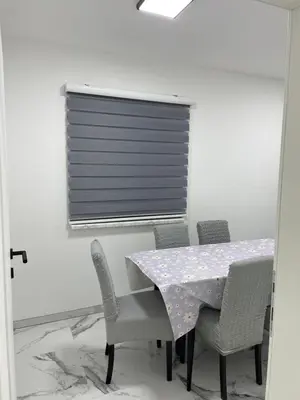 a dining room with a table and chairs and a window at Pišta-pause in Bihać