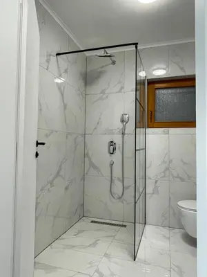 a glass shower in a bathroom with a toilet at Pišta-pause in Bihać