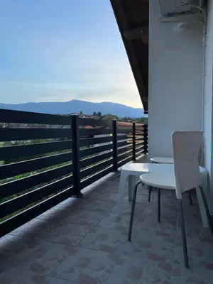 a white table and chair on a balcony with a view at Pišta-pause in Bihać
