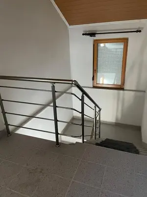 a stair railing in a room with a window at Pišta-pause in Bihać