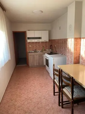 a kitchen with a table and a stove top oven at Pišta-pause in Bihać