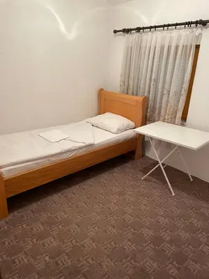 a bedroom with a bed and a table in it at Pišta-pause in Bihać