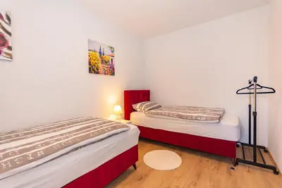 two beds in a small room with at Apartman Krželj B2 in Livno