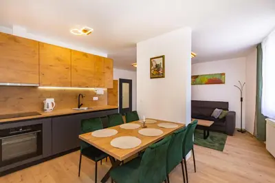 a kitchen and dining room with a table and chairs at Apartman Krželj B2 in Livno