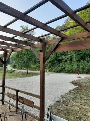 a wooden pavilion with a view of a road at AutoCamp Aqualand in Bihać