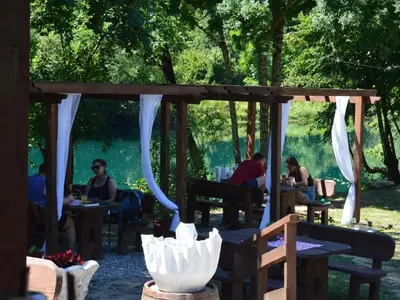 a group of people sitting at tables under a gazebo at AutoCamp Aqualand in Bihać