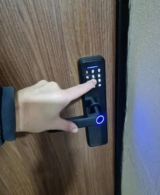 a person unlocking a door with a remote control at Luxury Apartment Tuzla in Tuzla