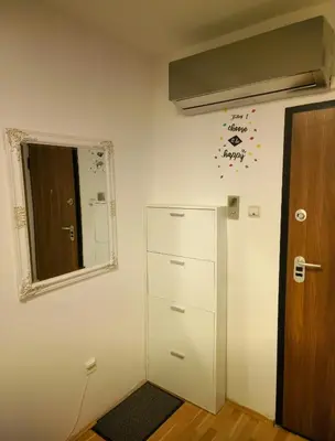 an empty room with a door and a mirror at Luxury Apartment Tuzla in Tuzla