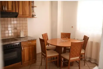 a kitchen with a table and chairs in a kitchen at Perisa in Livno