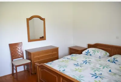 a bedroom with a bed and a mirror and a chair at Perisa in Livno