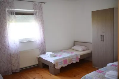 a small bedroom with two beds and a window at Perisa in Livno